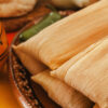 wooden table with one Order tamales online